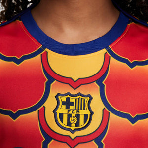 NIKE JR BARCELONA 23-24 PRE-MATCH SS TOP UNIVERSITY GOLD/MIDNIGHT NAV